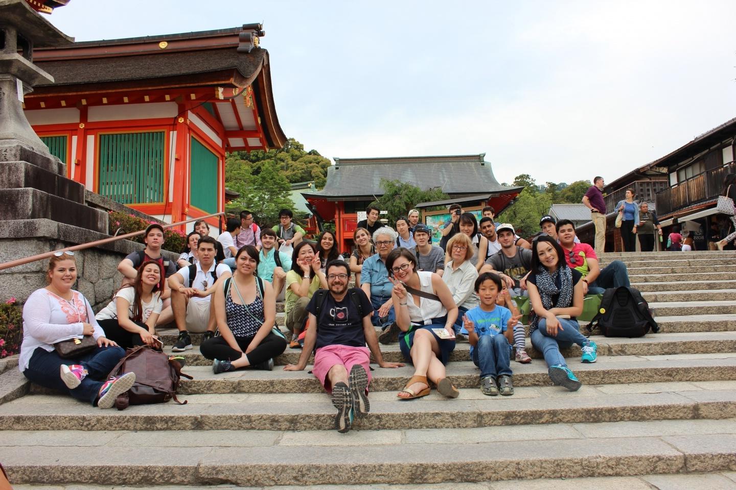 Students and faculty sitting on steps at a temple