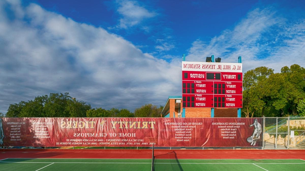 A banner honoring Trinity grads who have won major professional titles hangs on the back wall of the Trinity tennis courts