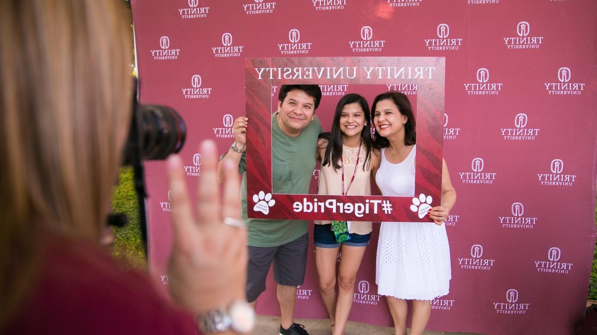 a family poses with a Tiger Pride picture frame